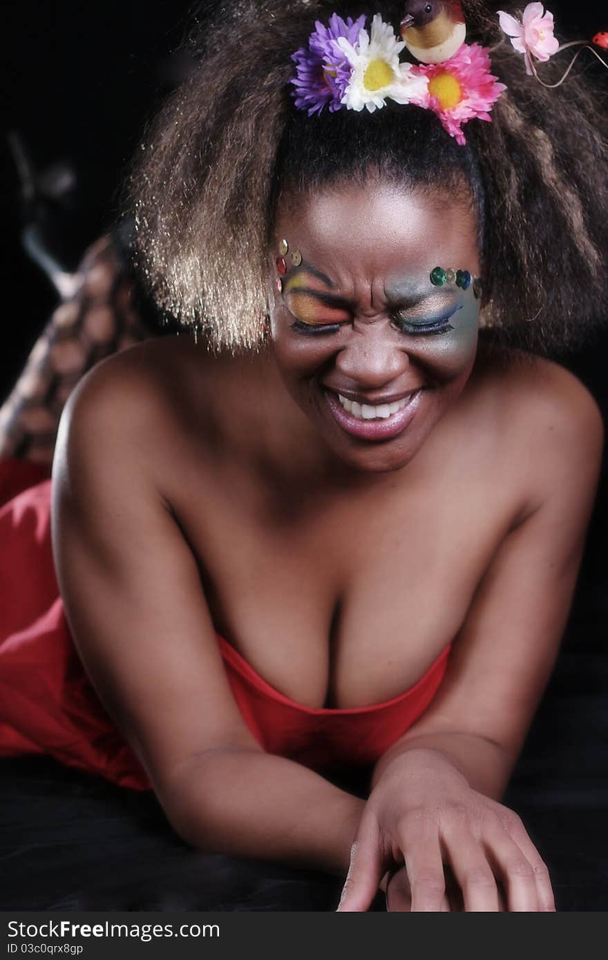 An African American woman wearing colorful makeup.