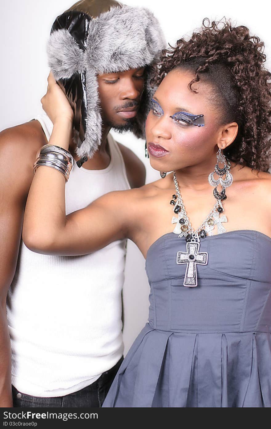 A man and woman standing against a white background. A man and woman standing against a white background