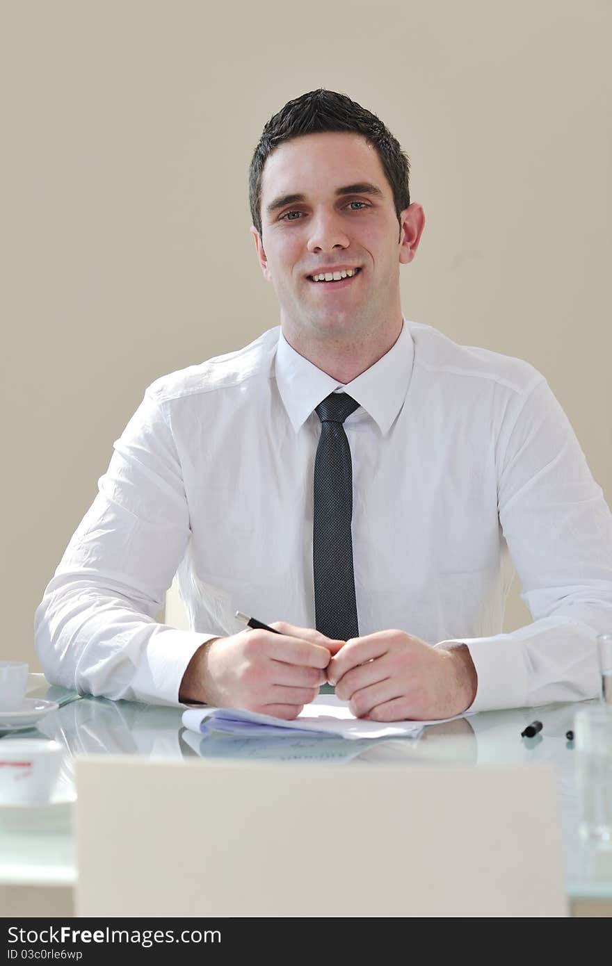 Young business man alone in conference room