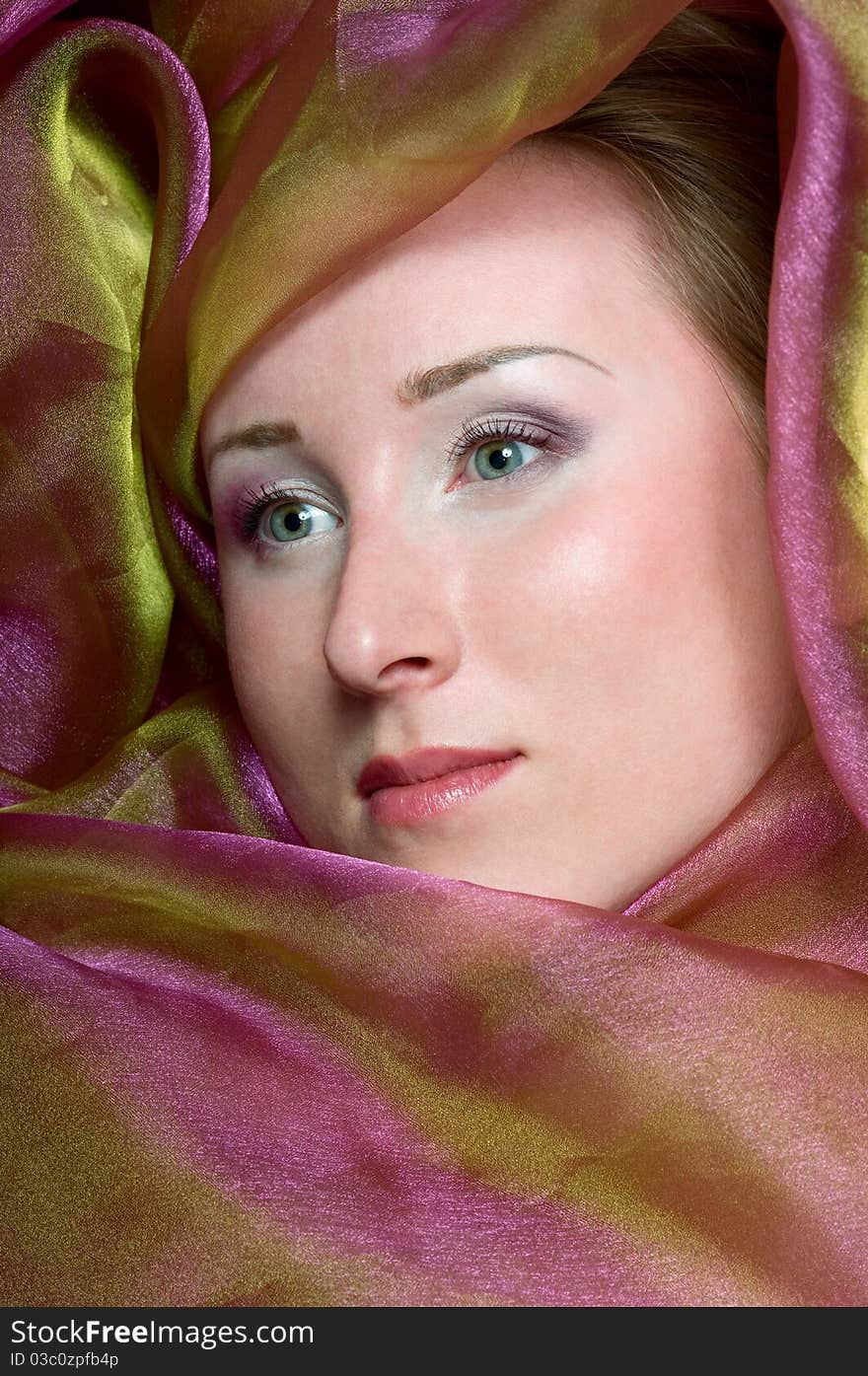 Portrait of a  women covered in violet fabrics