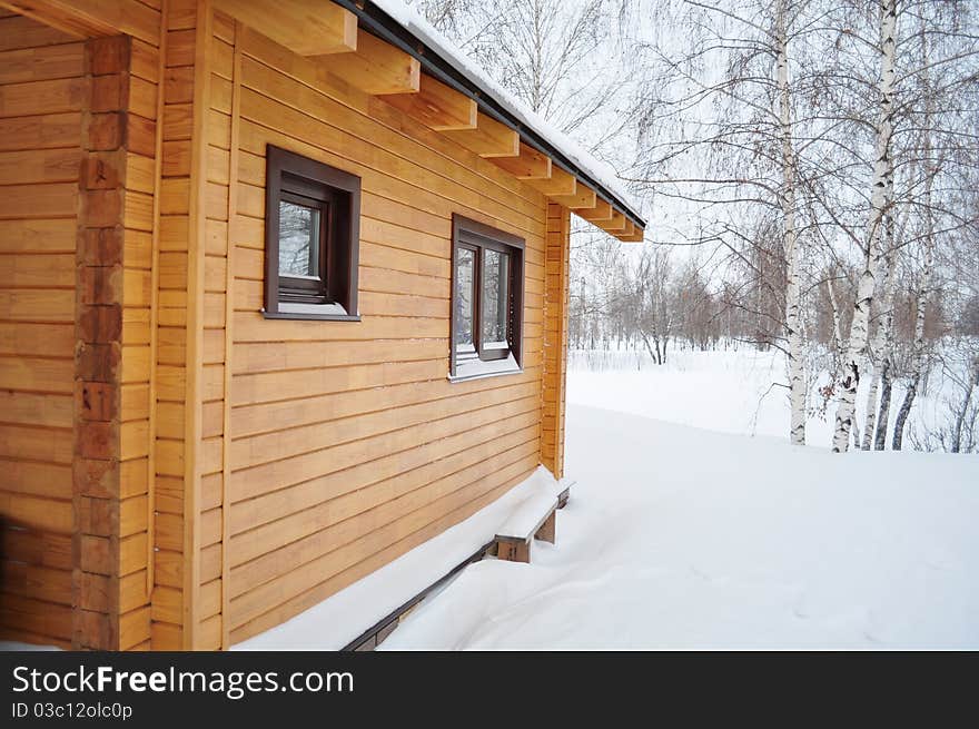 Suburban Building of the timber, warm home, tinted windows, practical impregnation, with access to nature, covered beautiful lacquer, winter and snow. Suburban Building of the timber, warm home, tinted windows, practical impregnation, with access to nature, covered beautiful lacquer, winter and snow