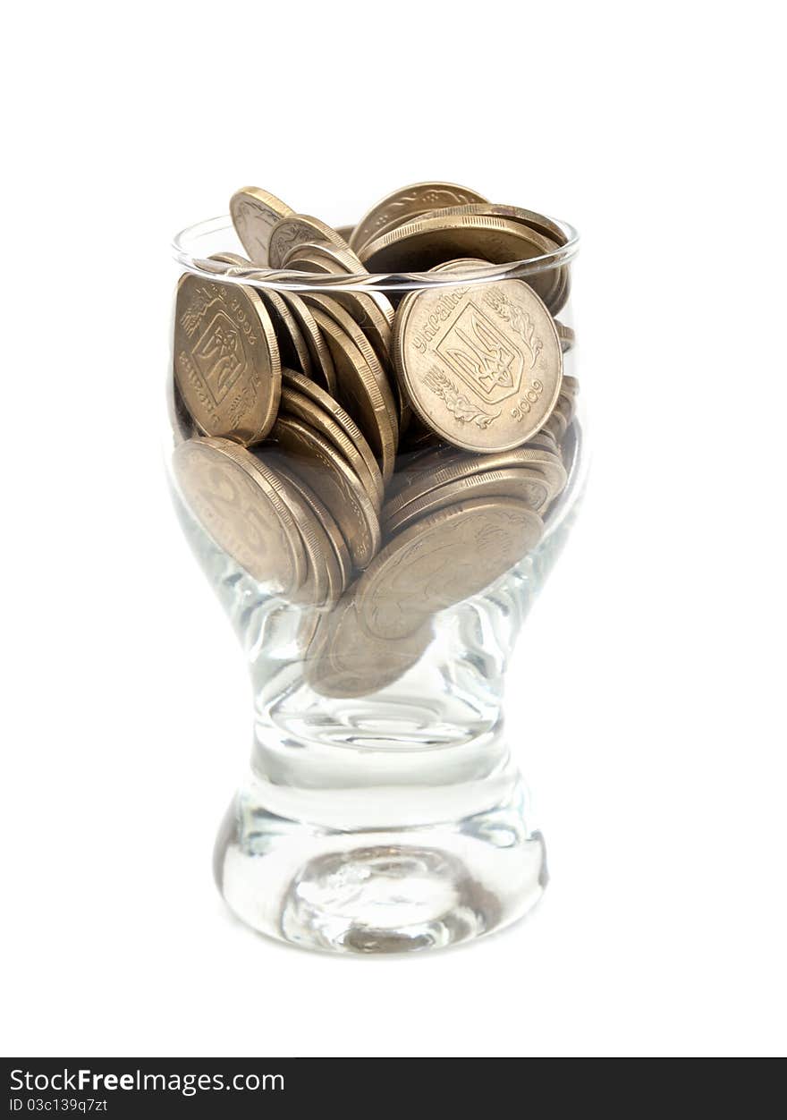 Coins in a glass isolated on a white background