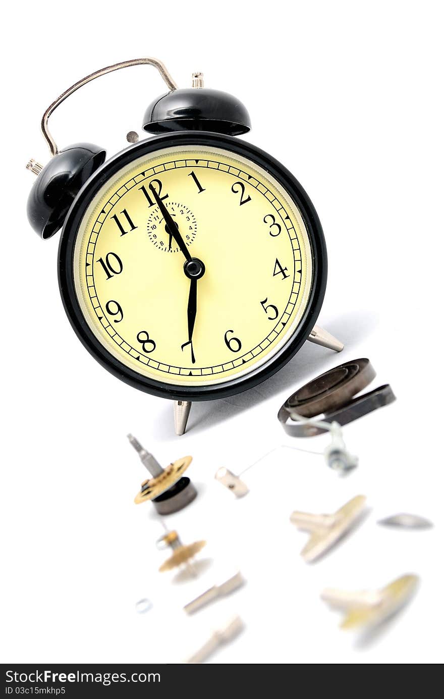 Broken alarm clock. Spare parts on a white background. Broken alarm clock. Spare parts on a white background