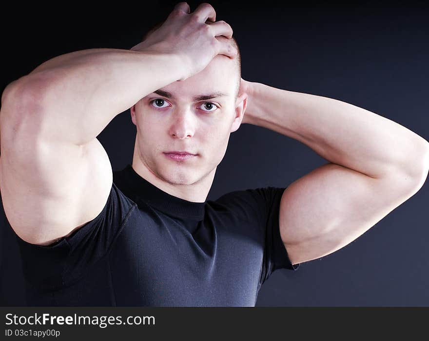 young man showing his muscular arms. young man showing his muscular arms