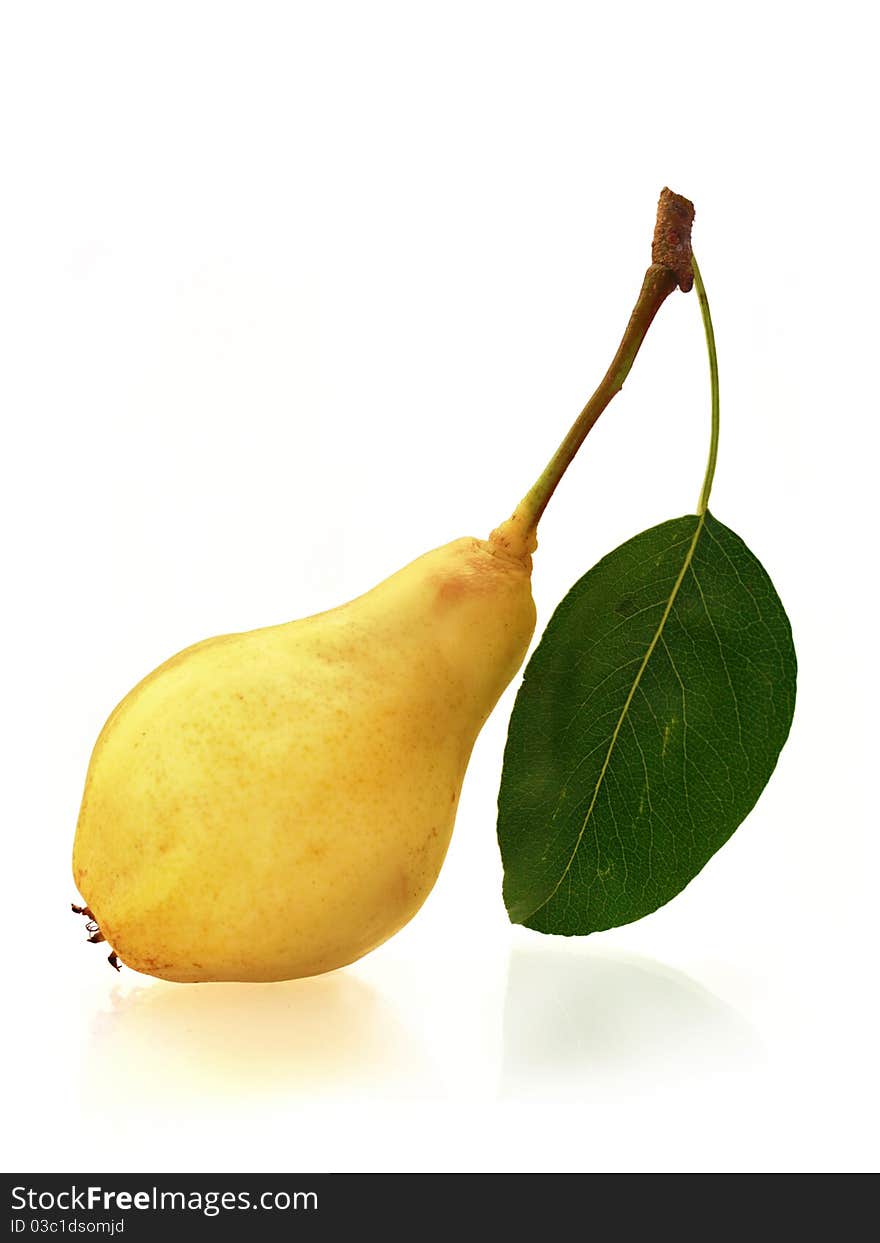 Tasty fresh pear with leaf on bright mirroring background. Tasty fresh pear with leaf on bright mirroring background