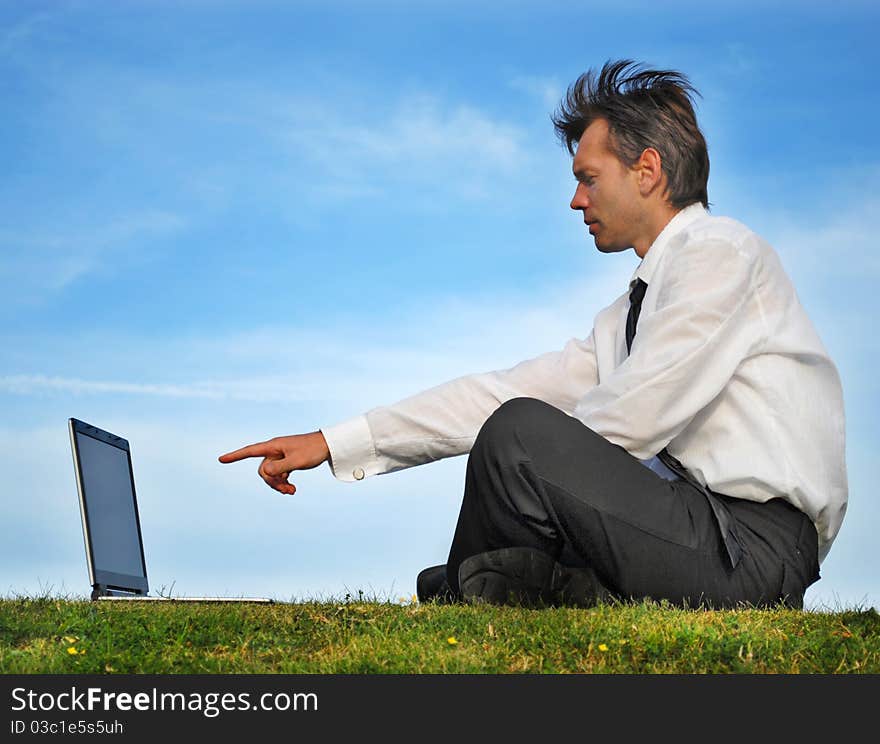 Young man pointing on his laptop. Young man pointing on his laptop