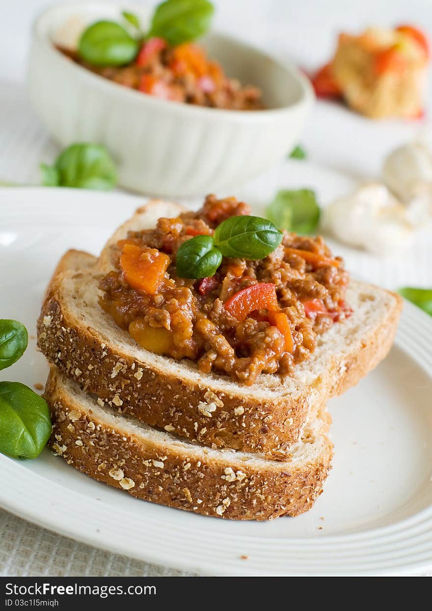 Sandwich of savory ground beef on toasted wholewheat bread. A delicious variety of a Sloppy Joe. Sandwich of savory ground beef on toasted wholewheat bread. A delicious variety of a Sloppy Joe.