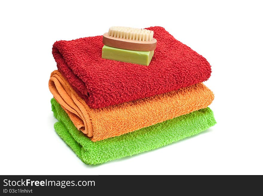 Stacked colorful towels isolated on a white background. Stacked colorful towels isolated on a white background.