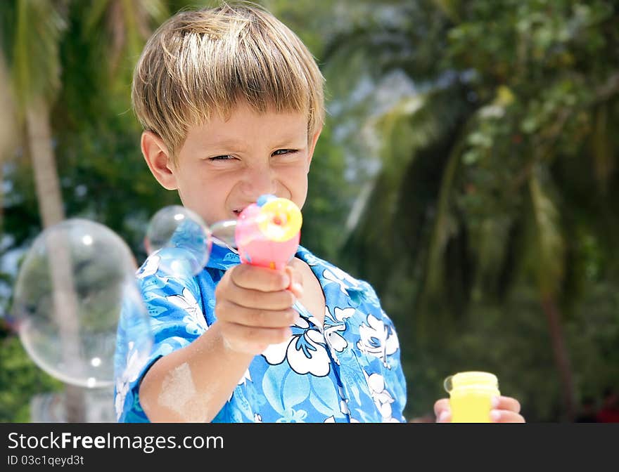 Young boy playing with bubbles