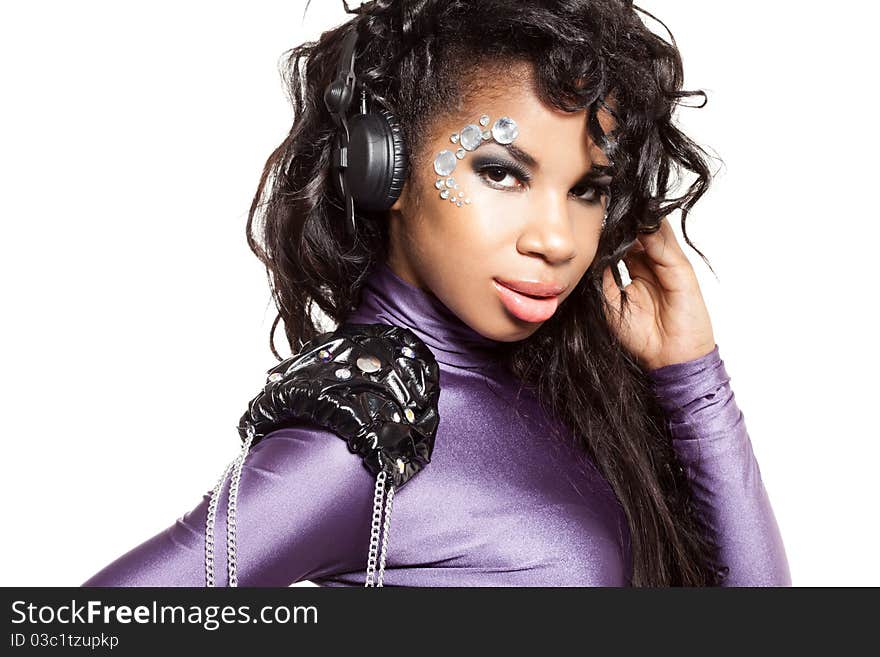 Mulatto girl DJ listens music with headphones