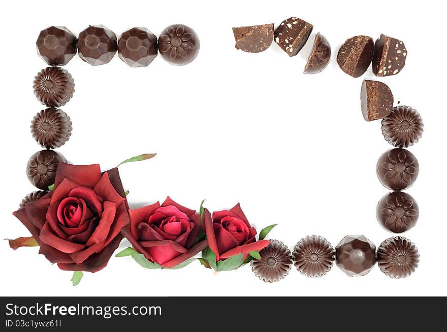 Beautiful red rose and chocolate frame on white background