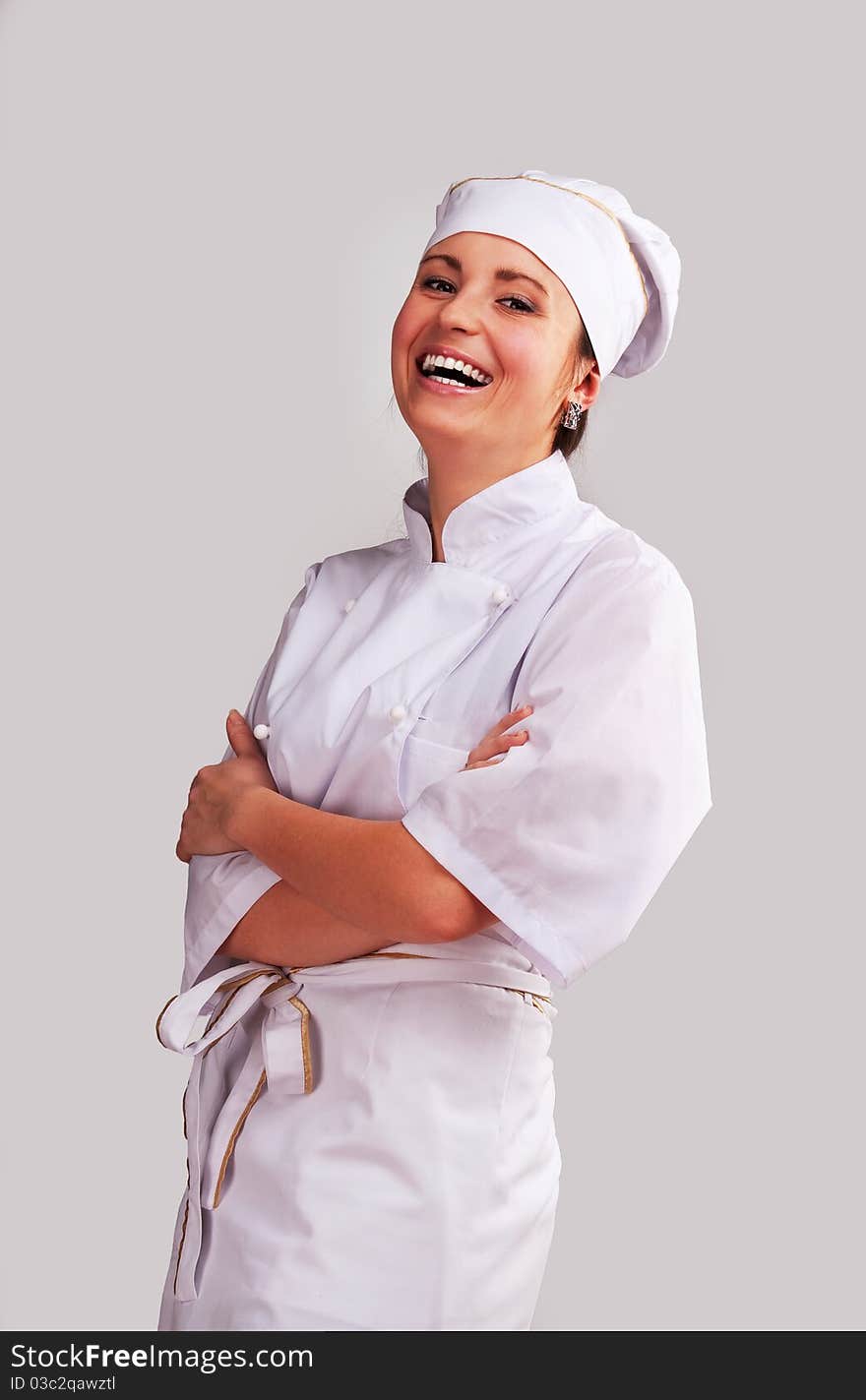 Young woman in white chef dress with hat. Young woman in white chef dress with hat