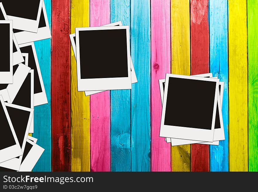 Blank photos on vintage multicolored wooden background