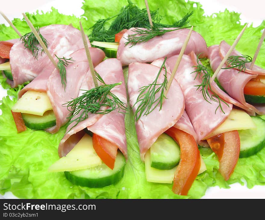 Bacon meat rolls on lettuce vegetable isolated on white. Bacon meat rolls on lettuce vegetable isolated on white