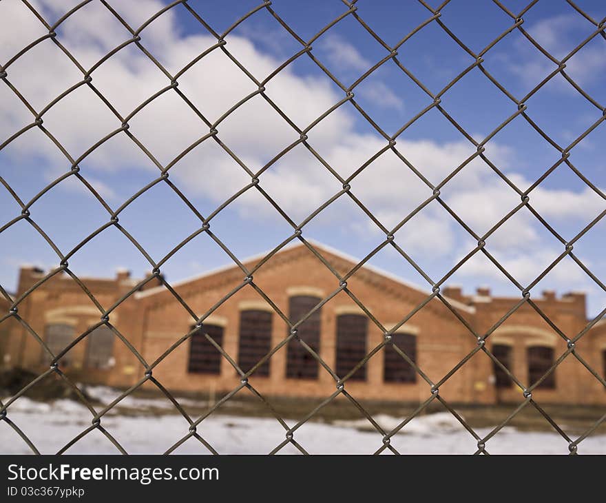 Brick Wall building behind a fence. Brick Wall building behind a fence