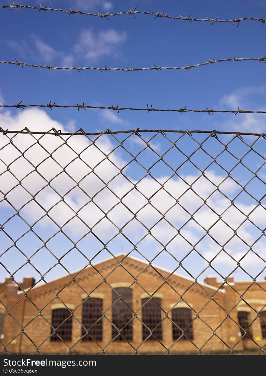 Brick Wall building behind a fence. Brick Wall building behind a fence