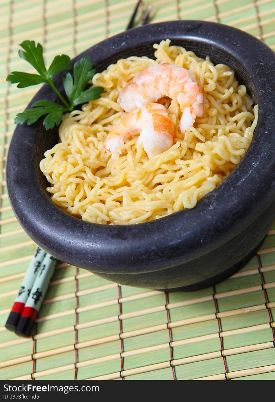 Chinese noodle with boiled prawn on wood background