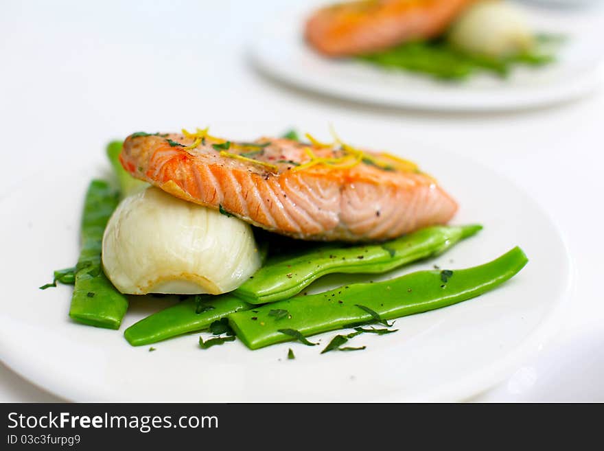 Salmon fillet with green beans and fennel on the white table