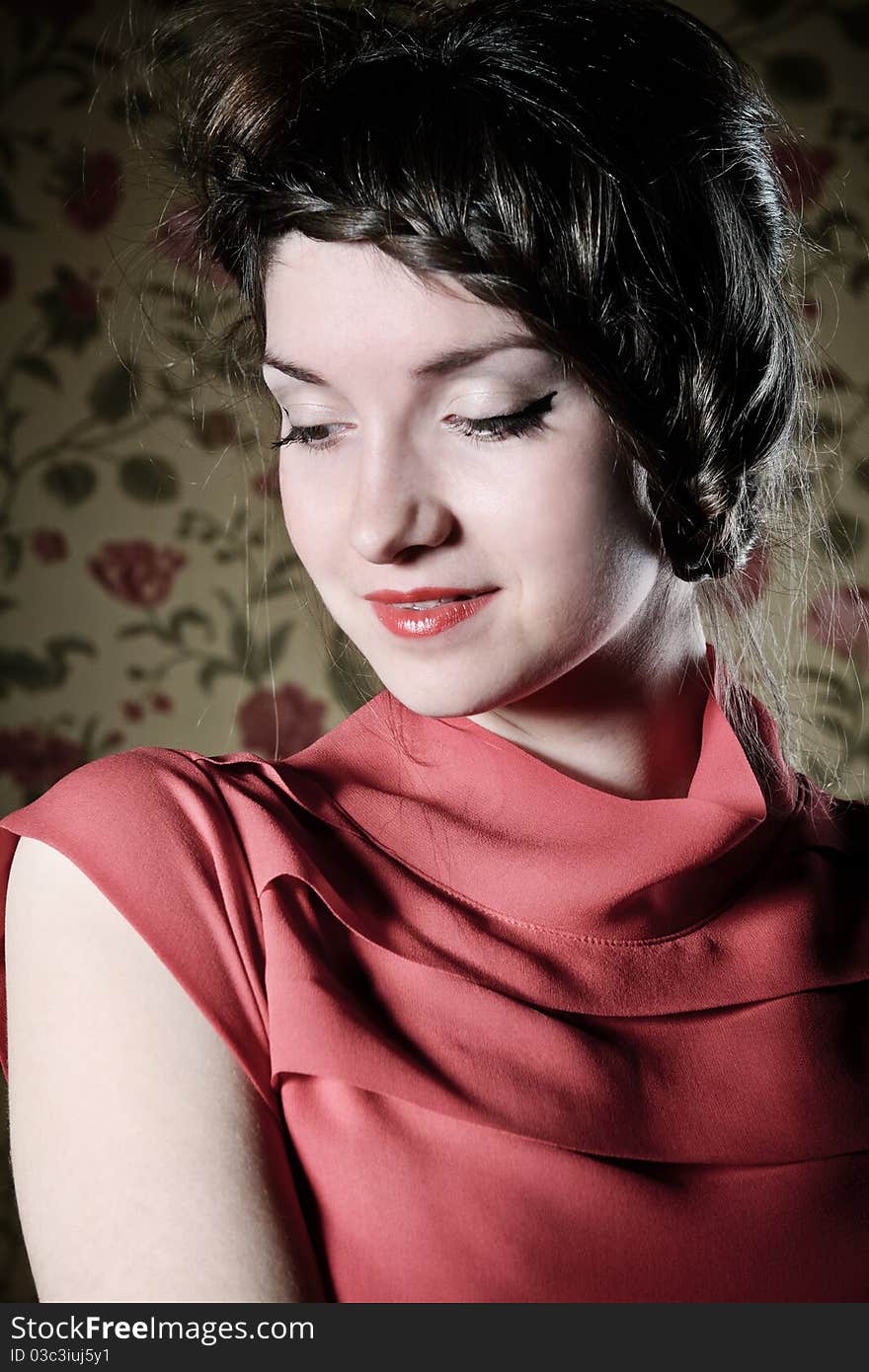 Portrait of the beautiful stylish brunette woman in red dress