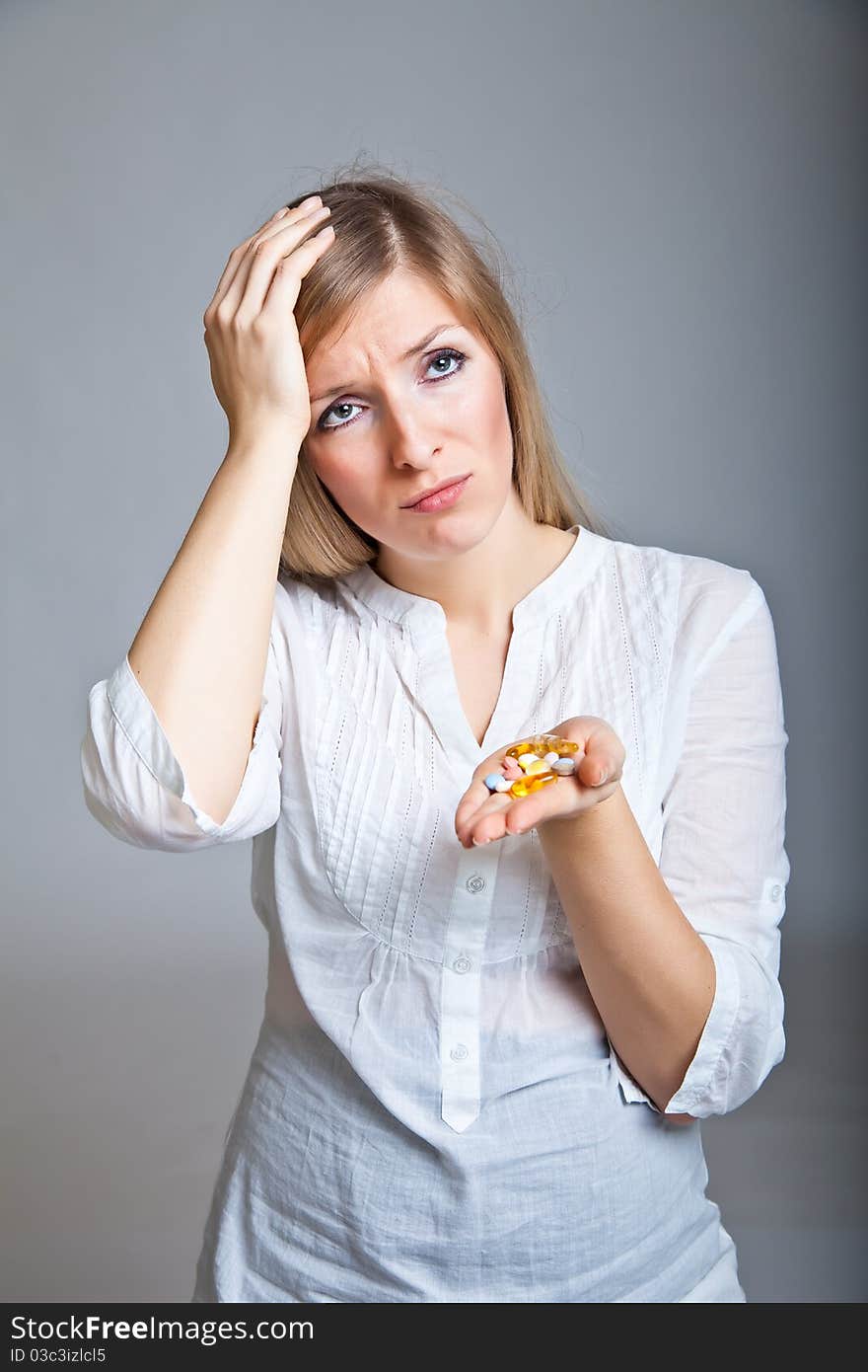 Woman holding pharmaceuticals on neutral bg. Woman holding pharmaceuticals on neutral bg