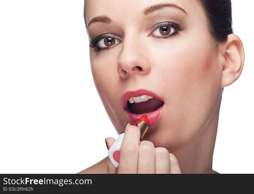 Applying with pink lipstick isolated on white