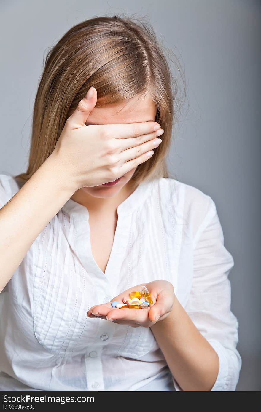 Woman holding pharmaceuticals on neutral bg. Woman holding pharmaceuticals on neutral bg