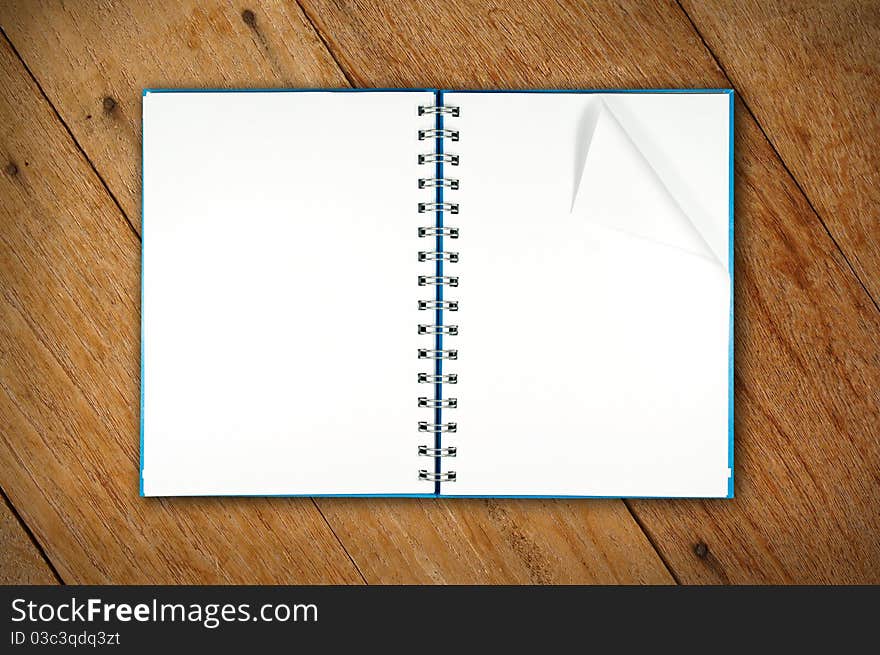 A notebook open on wood