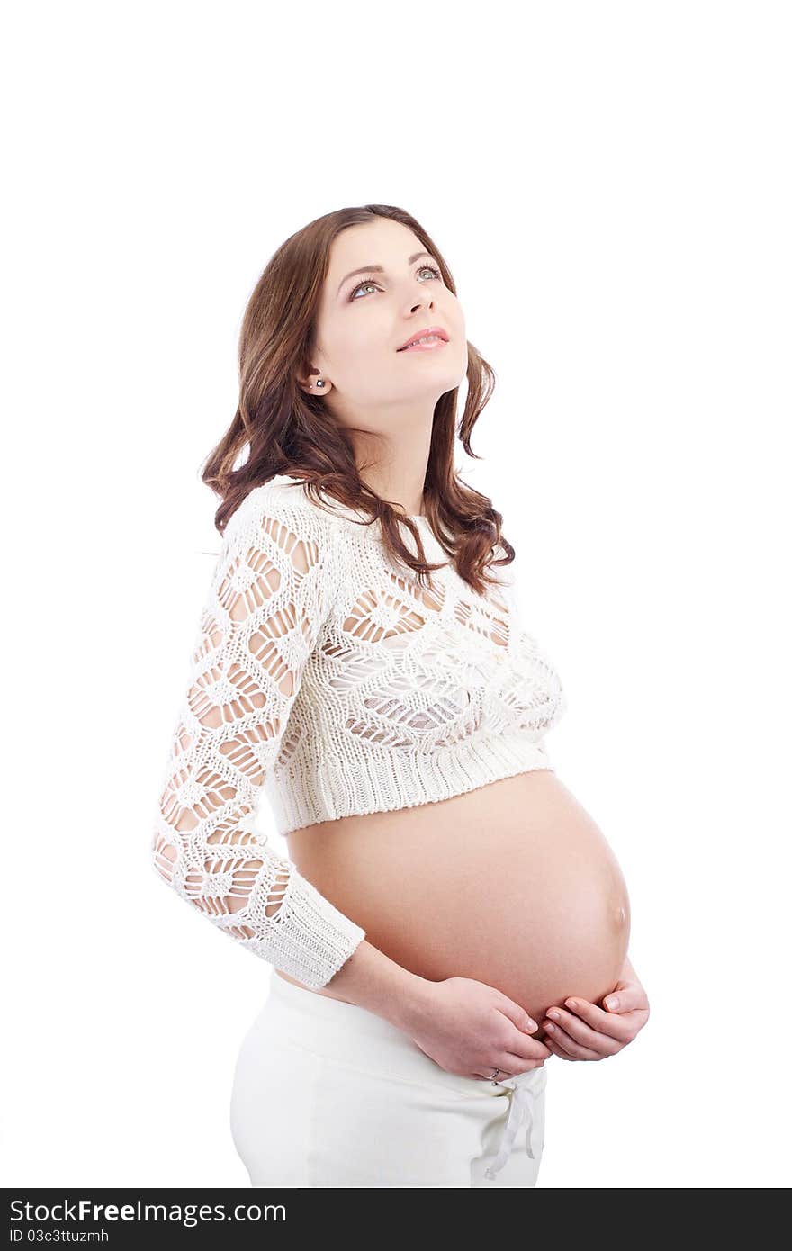 Studio portrait of pregnant dreaming woman holding her belly with hands looking up. Studio portrait of pregnant dreaming woman holding her belly with hands looking up