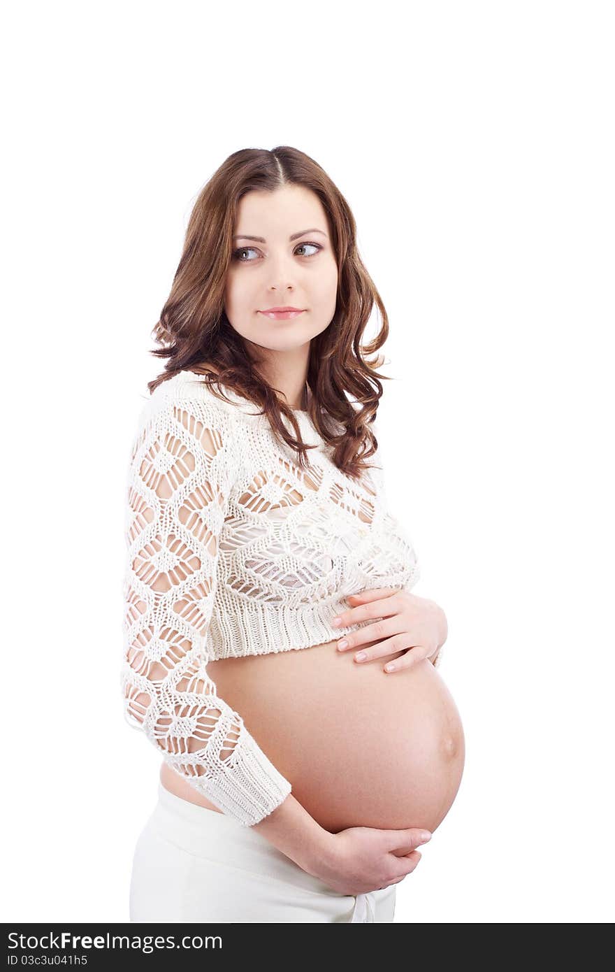 Studio portrait of pregnant curious woman holding her belly with hand