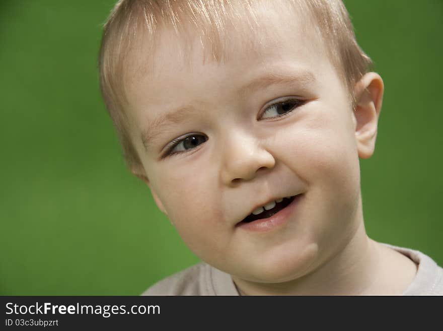 Lovely little boy on a green background