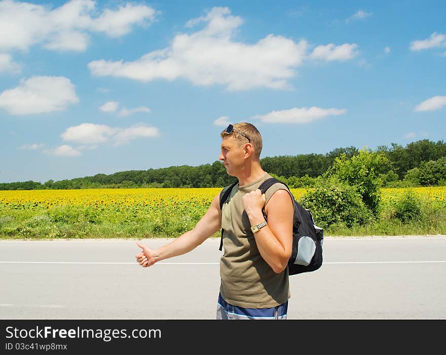 Man stops a cars on a road roadside