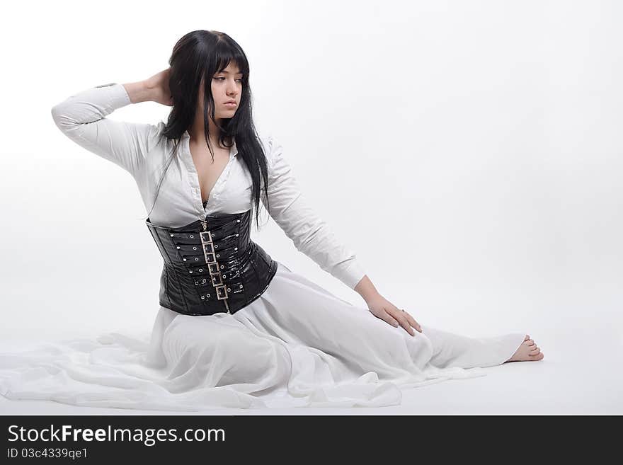 Woman in black corset and white dress isolated