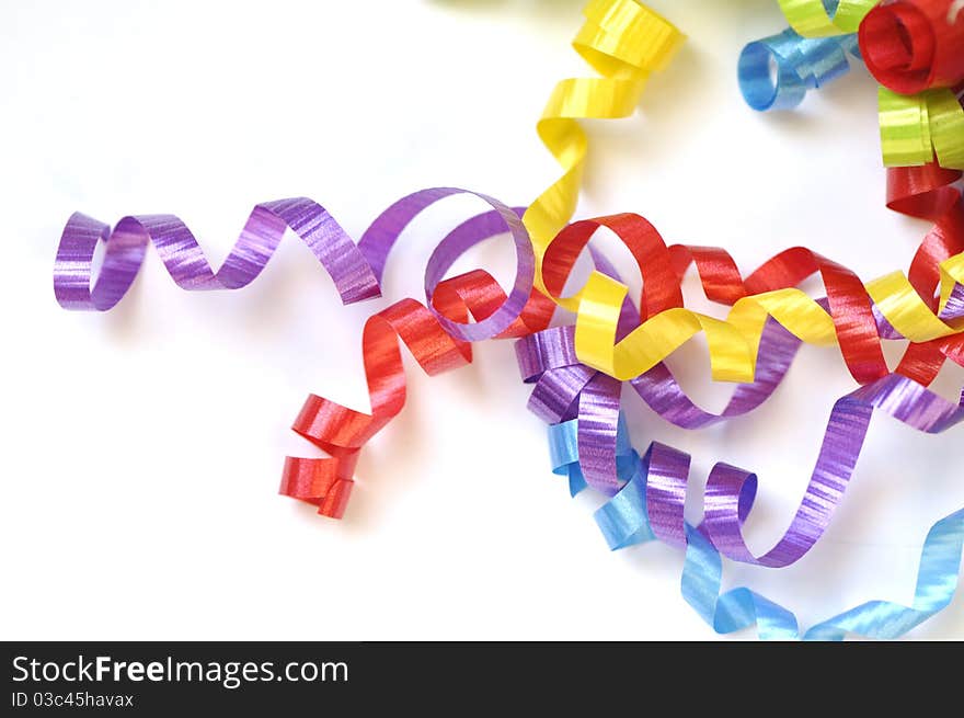 Colorful ribbons curled up on white space