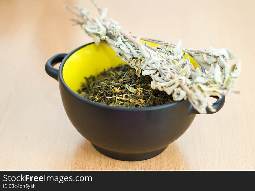 High Quality Green Tea closeup in the yellow bowl.