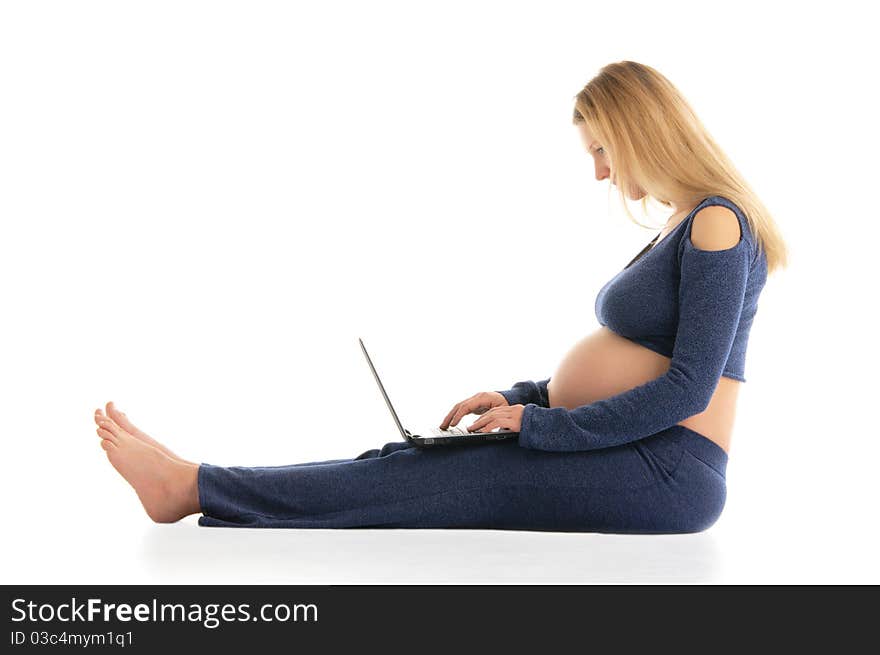 Pregnant Woman With A Laptop Sitting On The Floor