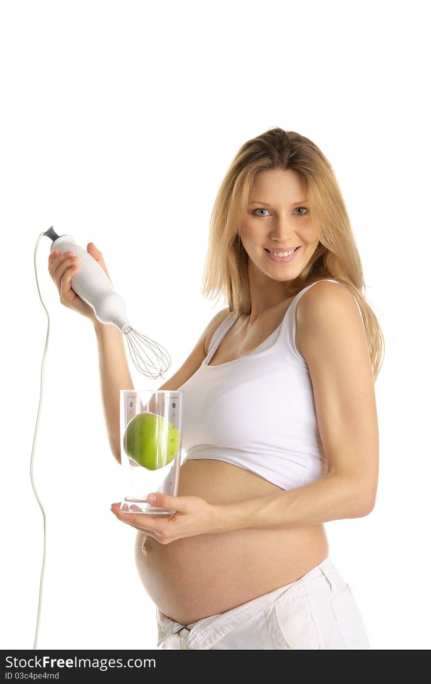 Pregnant woman with a blender and apple