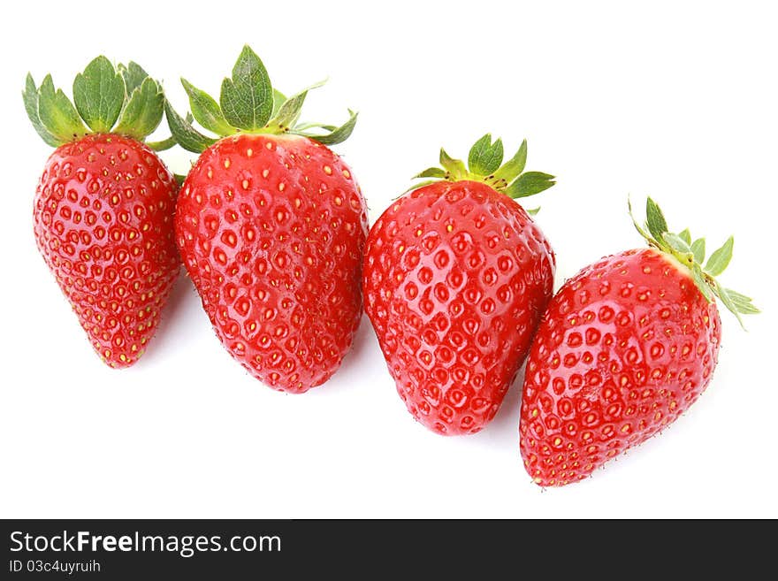 Four fresh strawberries isolated on white background.