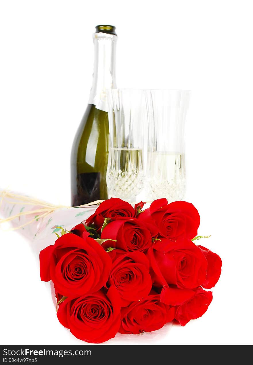 Champagne and roses for celebration of Valentines day with green bottle in background