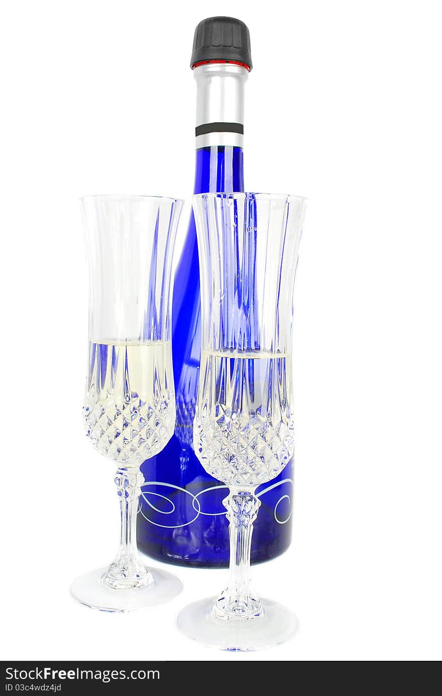 Champagne set with blue bottle and two crystal glasses isolated on the white background. Champagne set with blue bottle and two crystal glasses isolated on the white background.