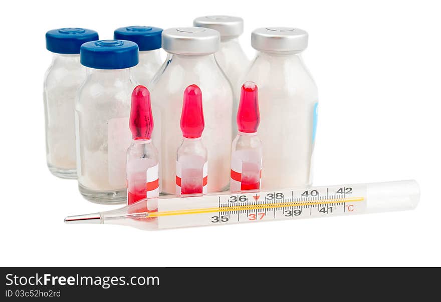 Ampoule, a thermometer and pills on a white background