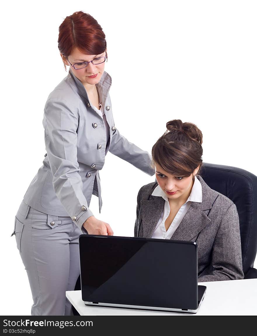 Two young businesswoman with laptop isolated over white