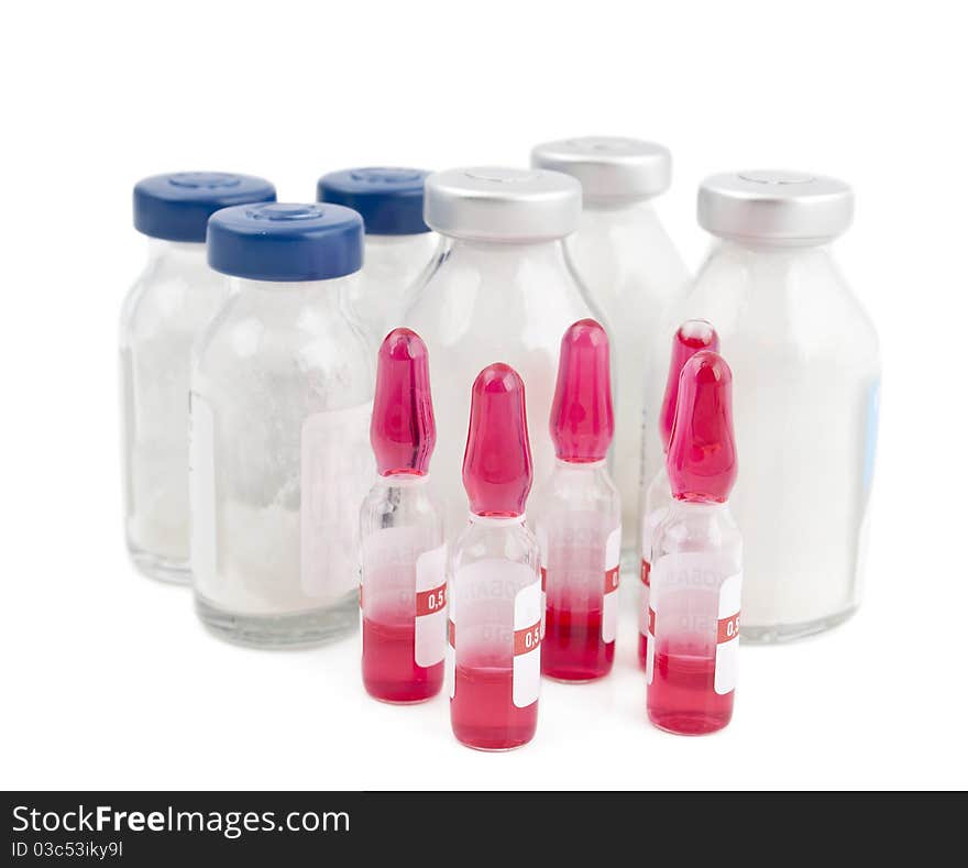 Ampoule and pills on a white background