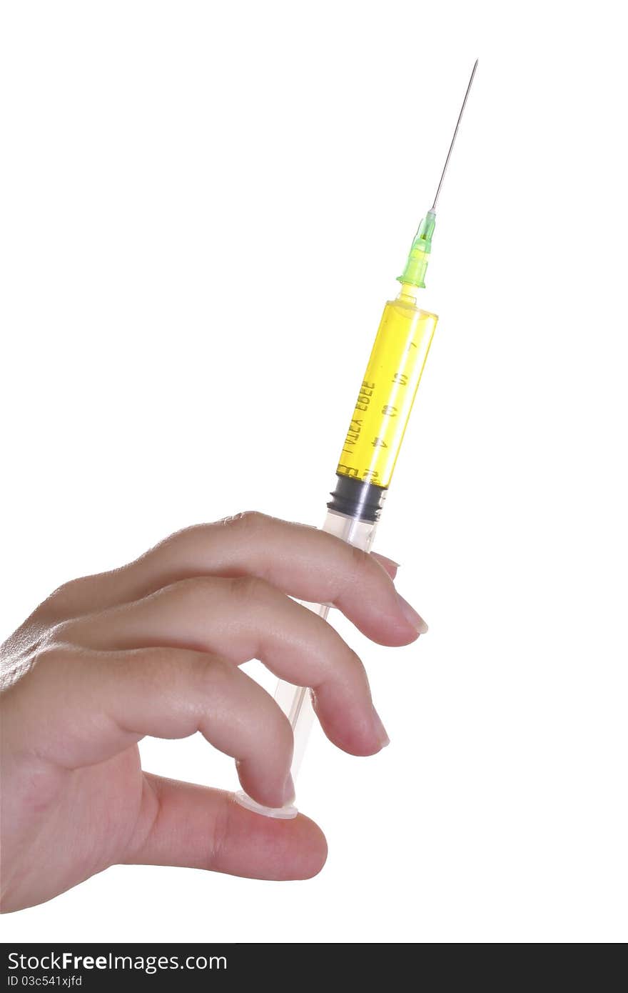 Hand holding syringe withe yellow content against white background. Hand holding syringe withe yellow content against white background