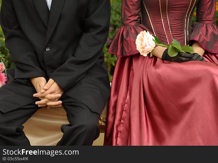 The loving couple sits on a bench in park, romantic mood