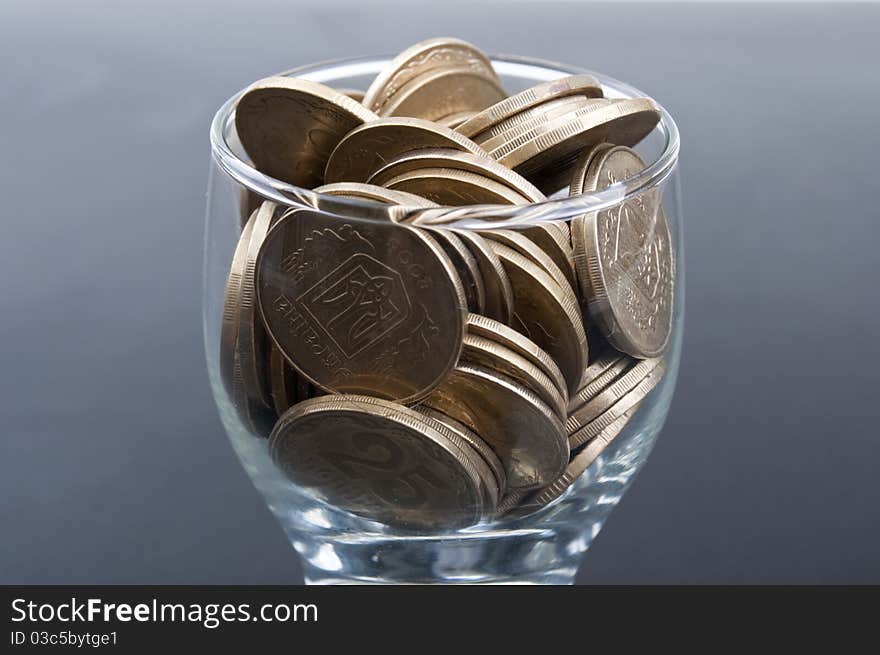 Coins in a glass on a black background