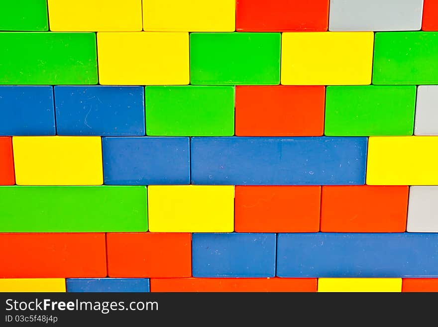 Background of plastic building blocks. Bright colors. Background of plastic building blocks. Bright colors.