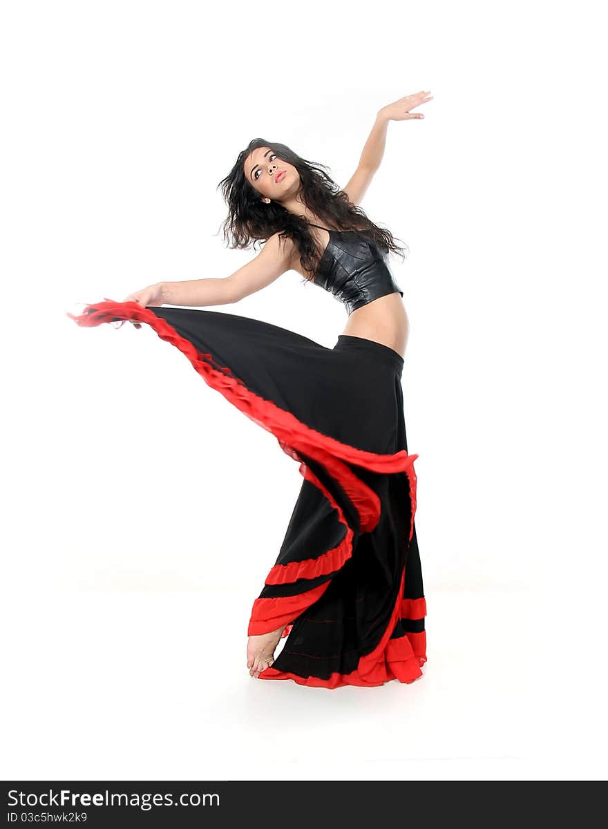 Studio portrait of young attractive woman dancing flamenco