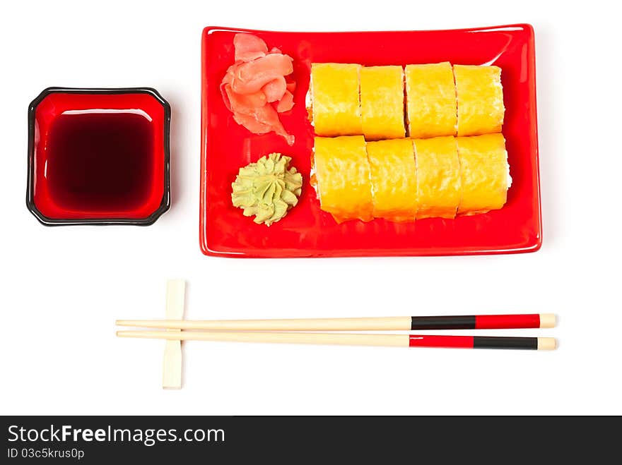 Yellow sushi rolls served on a plate. White background