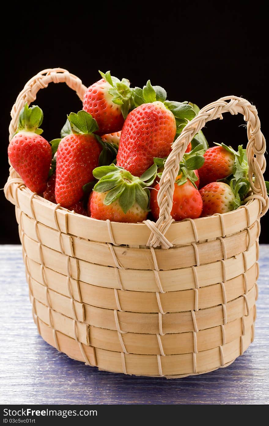 Photo of delicious red strawberries inside a basket