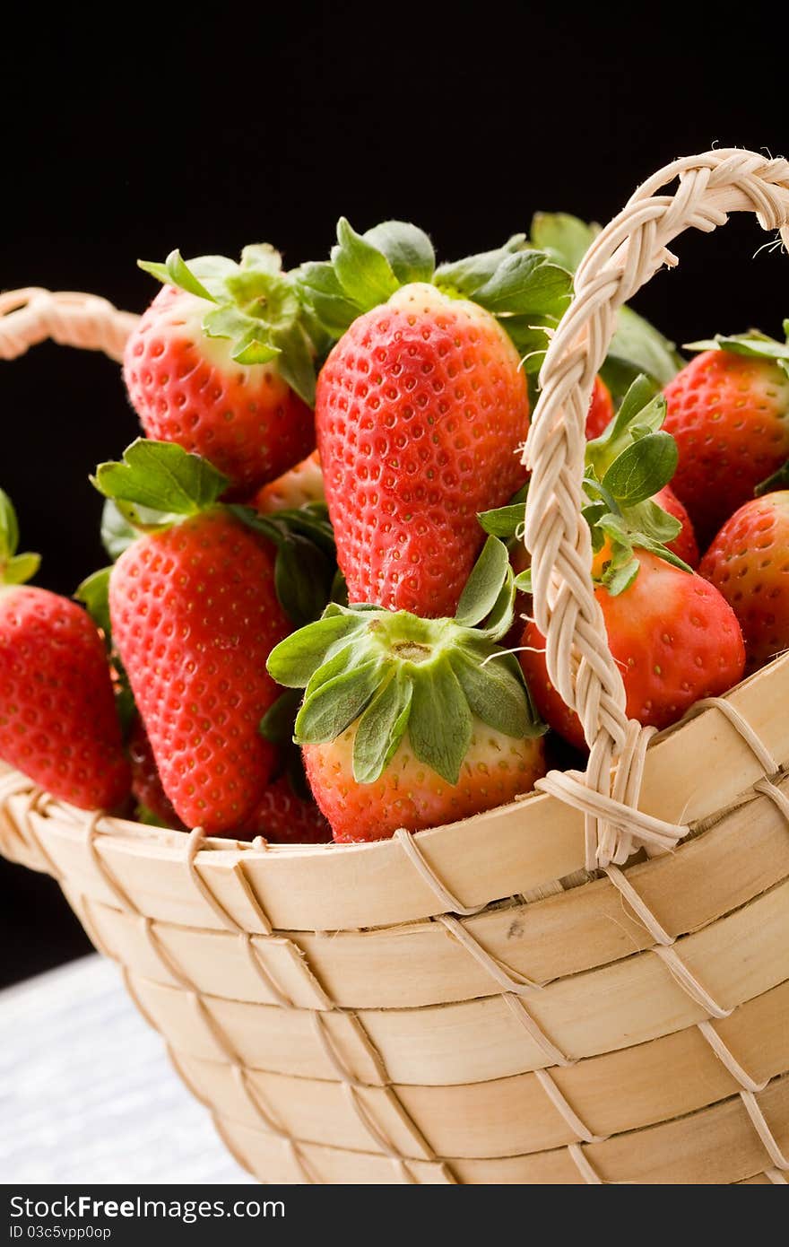 Photo of delicious red strawberries inside a basket